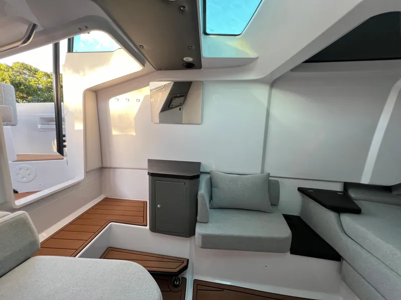 Slide: The Image of Interior of 2023 Axopar 37 Sun-Top boat with modern seating and skylight. - 23