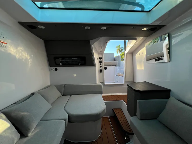 Slide: The Image of Interior of 2023 Axopar 37 Sun-Top boat with modern seating and skylight. - 27
