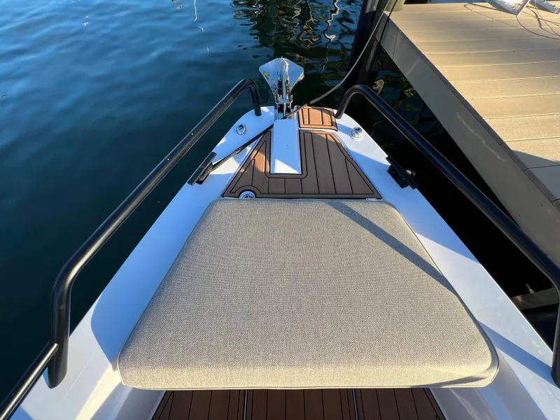 Slide: The Image of 2023 Axopar 37 Sun-Top bow with cushioned seating and teak decking. - 38