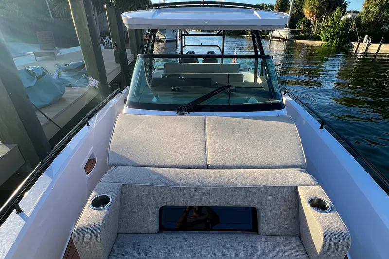 Slide: The Image of 2023 Axopar 37 Sun-Top boat with spacious seating and waterfront view. - 46