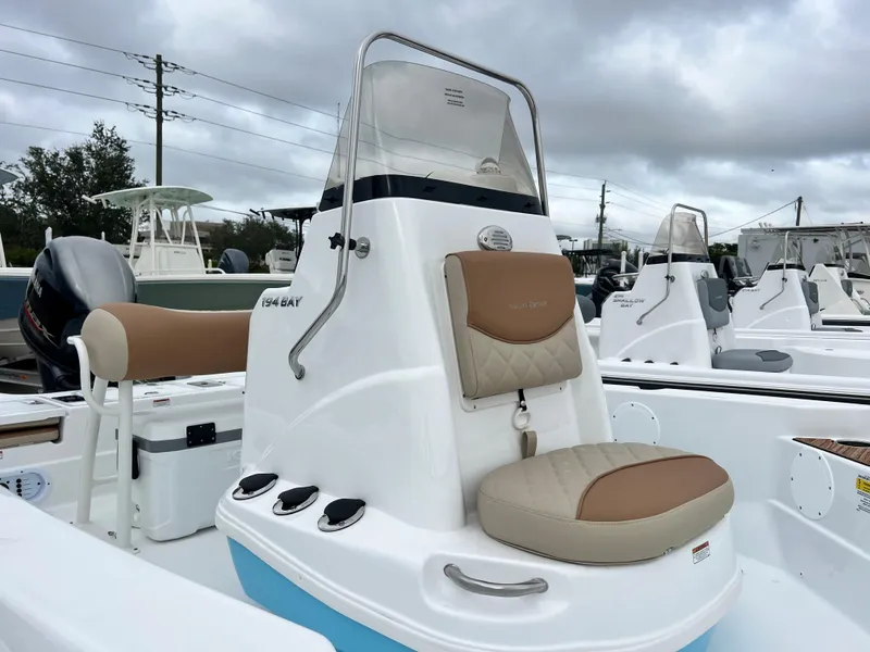 Slide: The Image of 2024 NauticStar 194 Bay boat with beige seating and console. - 3