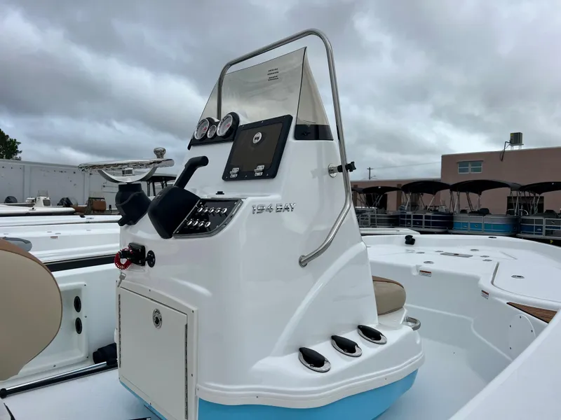 Slide: The Image of 2024 NauticStar 194 Bay boat console with controls and gauges. - 7
