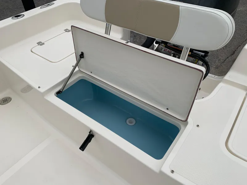 Slide: The Image of Bulls Bay 2400 boat livewell, open lid, 2025 model, white interior, blue compartment. - 10