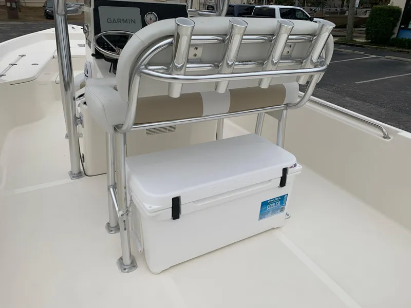Slide: The Image of 2025 Bulls Bay 2400 boat interior with rod holders and cooler. - 11