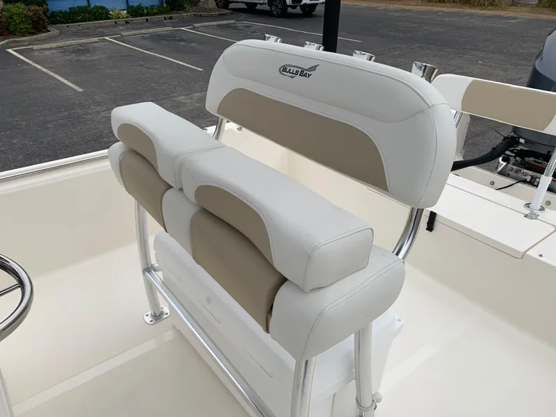 Slide: The Image of 2025 Bulls Bay 2400 boat seating with white and beige cushioned design. - 13