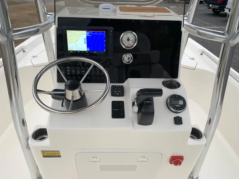 Slide: The Image of 2025 Bulls Bay 2400 boat dashboard with steering wheel, gauges, and navigation display. - 16