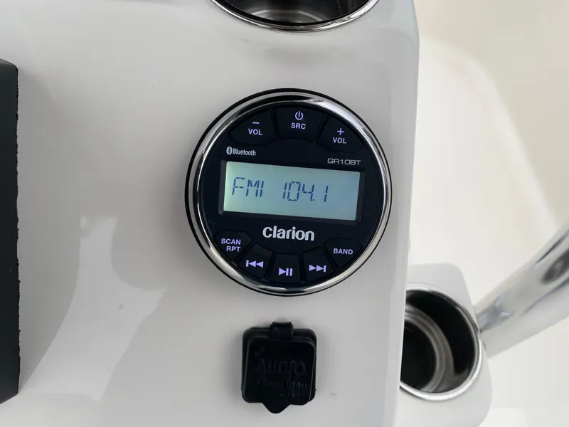 Slide: The Image of Clarion radio display on 2025 Bulls Bay 2400 boat, showing FM 104.1 frequency. - 18