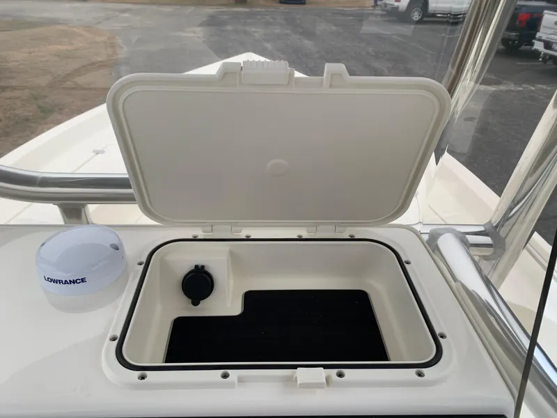 Slide: The Image of Open storage compartment on 2025 Bulls Bay 2400 boat with Lowrance device nearby. - 19