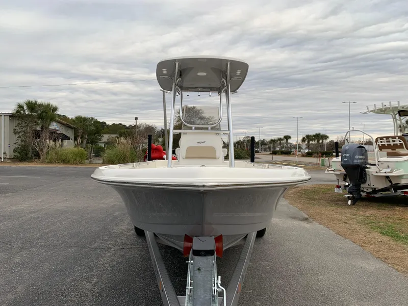 Slide: The Image of 2025 Bulls Bay 2400 boat on trailer, parked outdoors under cloudy sky. - 7