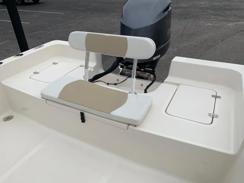 Slide: The Image of 2025 Bulls Bay 2400 boat with cushioned seating and outboard motor. - 9