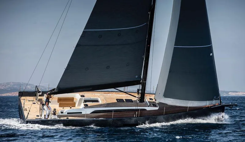 Slide: The Image of 2025 Solaris 50 yacht sailing on open sea with sleek design and dark sails. - 3