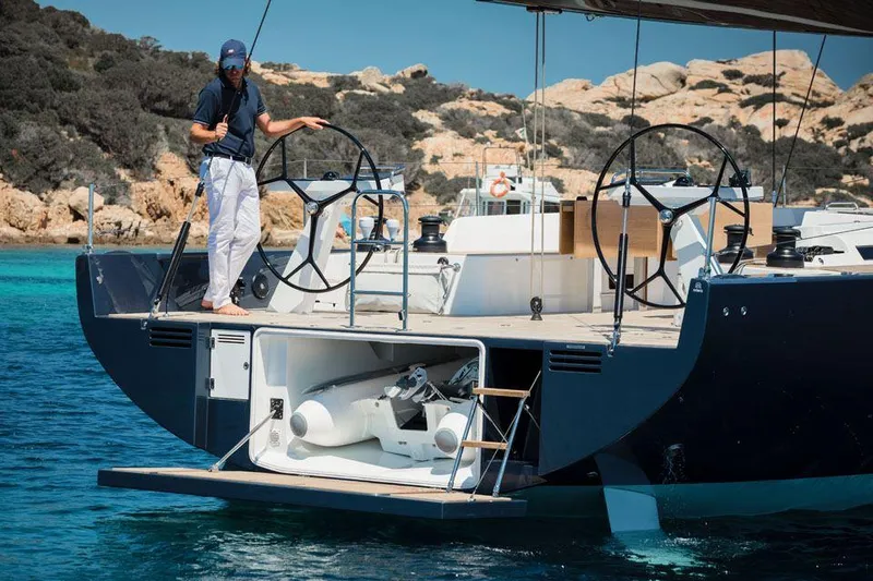 Slide: The Image of Man on Solaris 50 yacht, 2025 model, with open storage compartment, scenic coastal backdrop. - 5