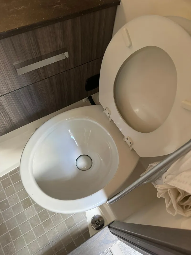 Slide: The Image of 2021 Sea Ray 400 SLX OB boat bathroom with modern toilet and cabinetry. - 14