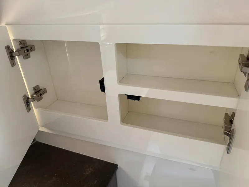 Slide: The Image of Open storage compartments in a 2021 Sea Ray 400 SLX OB boat. - 15