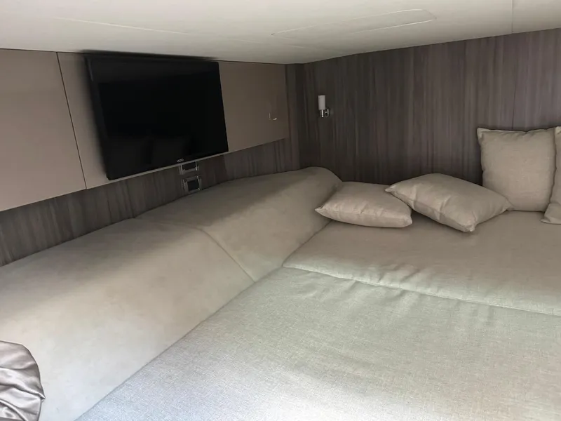 Slide: The Image of Interior cabin of 2021 Sea Ray 400 SLX OB with bed and TV. - 18