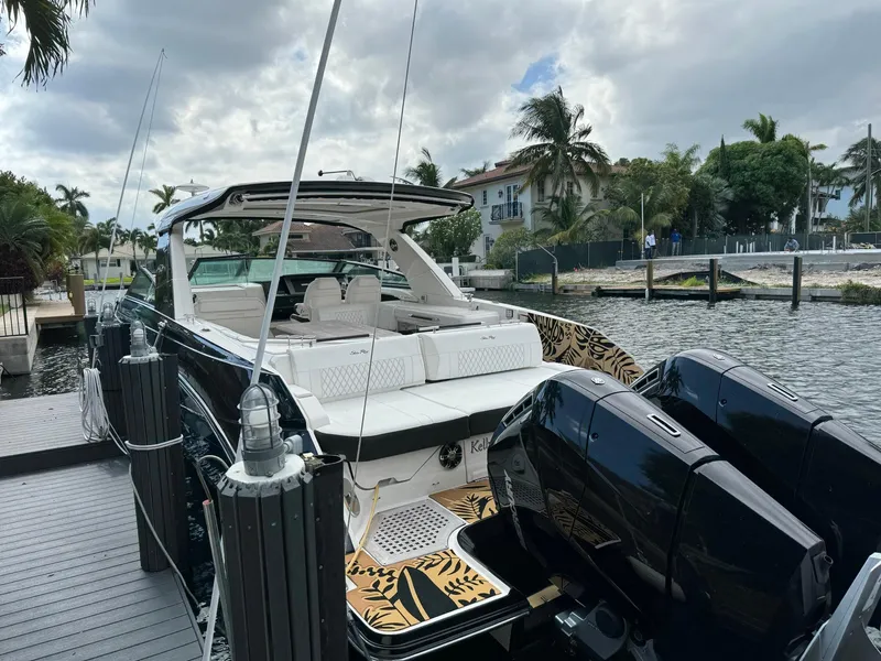 Slide: The Image of 2021 Sea Ray 400 SLX OB luxury boat docked at marina. - 2