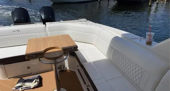 Slide: The Image of 2021 Sea Ray 400 SLX OB boat with white seating and wooden table on the deck. - 21