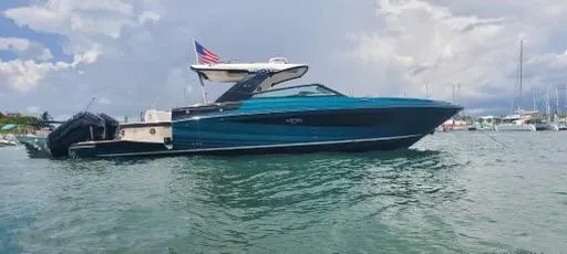 Slide: The Image of 2021 Sea Ray 400 SLX OB luxury boat on water with American flag. - 22