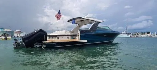 Slide: The Image of 2021 Sea Ray 400 SLX OB luxury boat on water with American flag. - 24