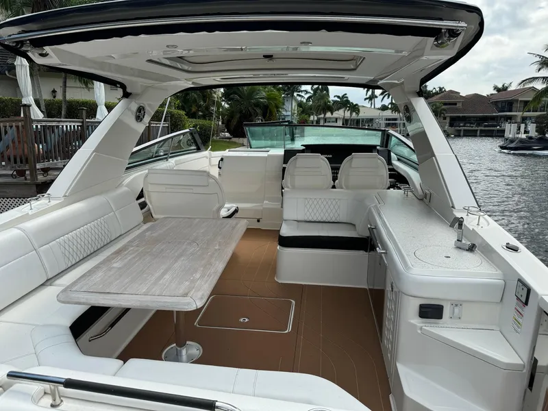 Slide: The Image of 2021 Sea Ray 400 SLX OB boat interior with seating and table. - 4
