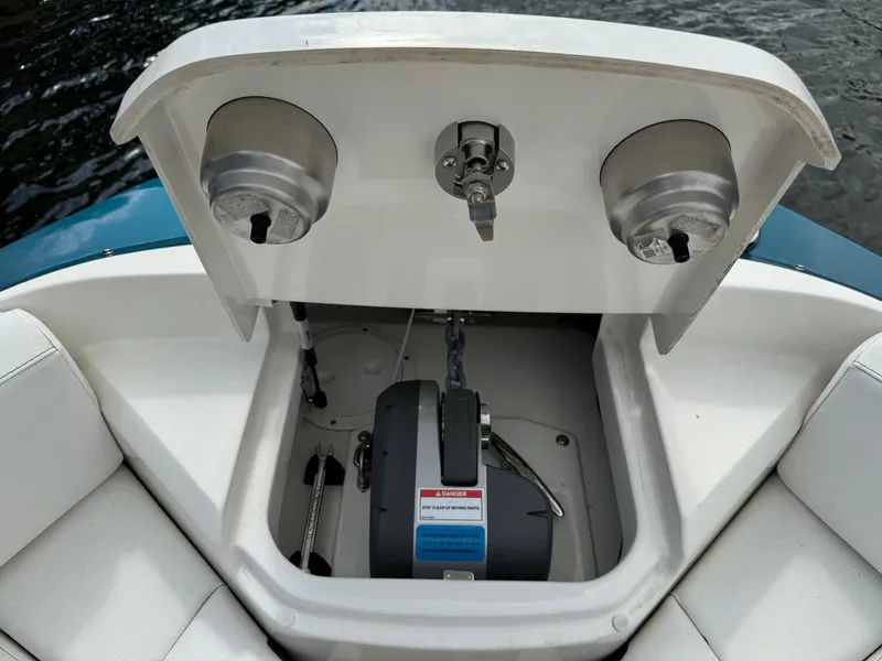 Slide: The Image of 2021 Sea Ray 400 SLX OB anchor storage compartment with winch and chain. - 7