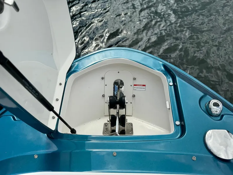 Slide: The Image of 2021 Sea Ray 400 SLX OB anchor compartment with open hatch. - 8