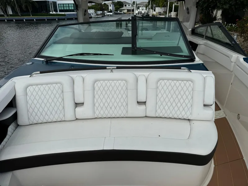Slide: The Image of 2021 Sea Ray 400 SLX OB boat with white leather seating and windshield. - 9
