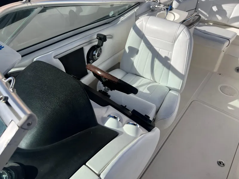 Slide: The Image of 2007 Sea Ray 250 SLX boat interior with white captain's seat and steering wheel. - 12