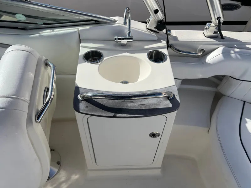 Slide: The Image of 2007 Sea Ray 250 SLX boat interior with sink and storage. - 14