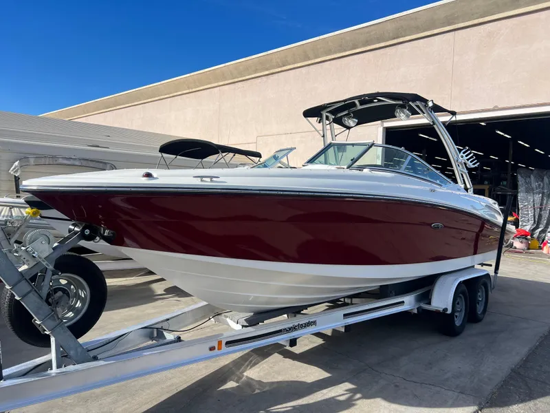 Slide: The Image of 2007 Sea Ray 250 SLX boat on a trailer outside a warehouse. - 3