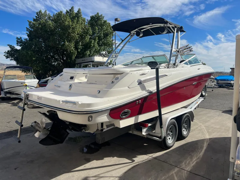 Slide: The Image of 2007 Sea Ray 250 SLX boat on a trailer, red and white, parked outdoors. - 5