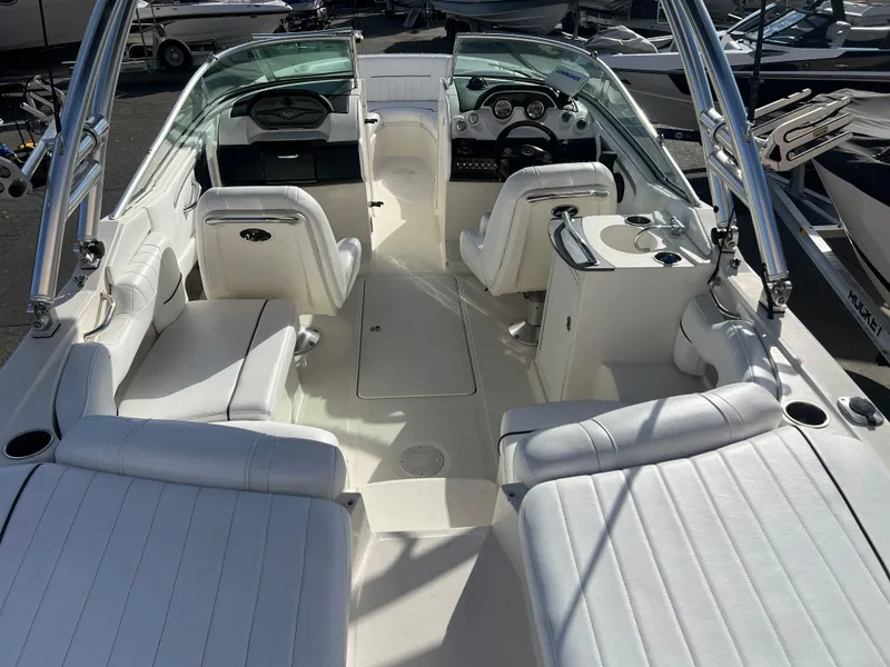 Slide: The Image of 2007 Sea Ray 250 SLX boat interior with white seating and dashboard. - 7