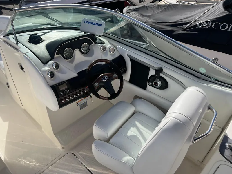 Slide: The Image of 2007 Sea Ray 250 SLX boat cockpit with white leather seats and Lowrance navigation system. - 8