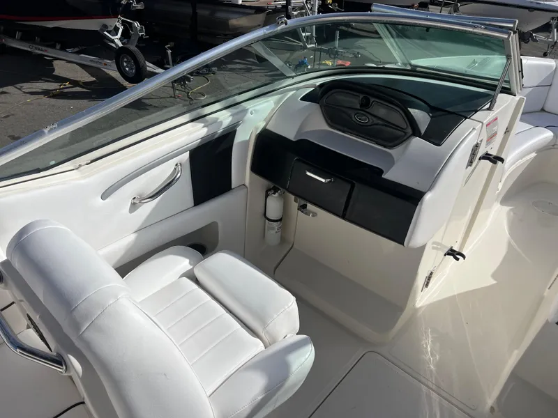 Slide: The Image of 2007 Sea Ray 250 SLX boat interior with white seating and dashboard. - 9