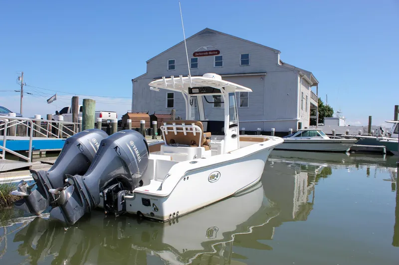 The Image of 2020 Sea Hunt Gamefish 25 boat docked at marina with twin Yamaha engines. - 0