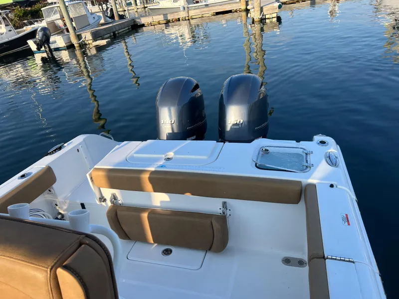 Slide: The Image of 2020 Sea Hunt Gamefish 25 boat with twin outboard motors docked at marina. - 12