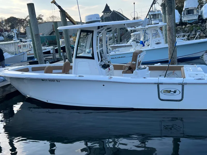 Slide: The Image of 2020 Sea Hunt Gamefish 25 boat docked at a marina. - 22