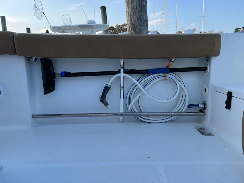 Slide: The Image of Storage compartment on a 2020 Sea Hunt Gamefish 25 boat with hose and equipment. - 23