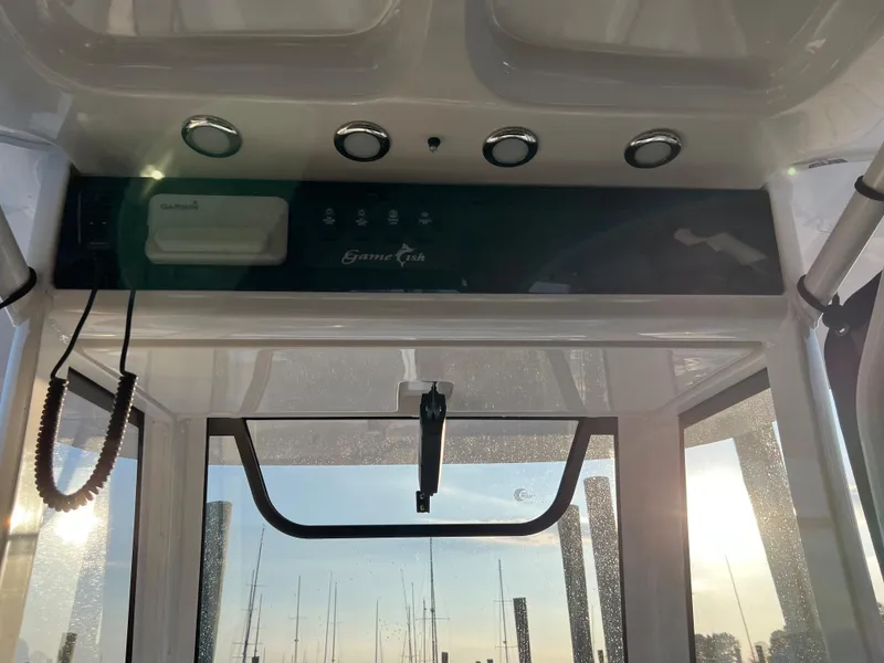 Slide: The Image of 2020 Sea Hunt Gamefish 25 boat console with electronics and controls. - 27