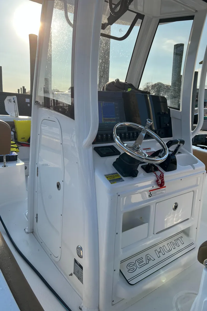 Slide: The Image of 2020 Sea Hunt Gamefish 25 boat console with steering wheel and navigation equipment. - 37