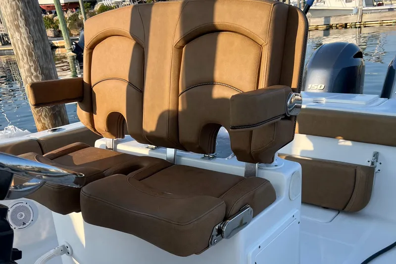 Slide: The Image of 2020 Sea Hunt Gamefish 25 boat with brown cushioned seats at the helm. - 38