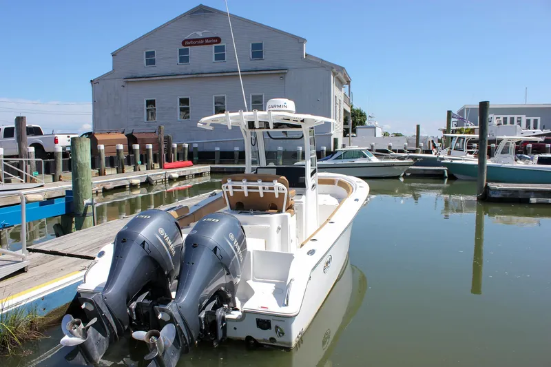 Slide: The Image of 2020 Sea Hunt Gamefish 25 boat docked at a marina with twin Yamaha engines. - 4