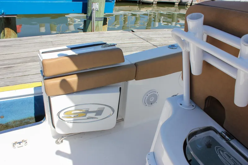 Slide: The Image of 2020 Sea Hunt Gamefish 25 boat interior with seating and rod holders at dock. - 41
