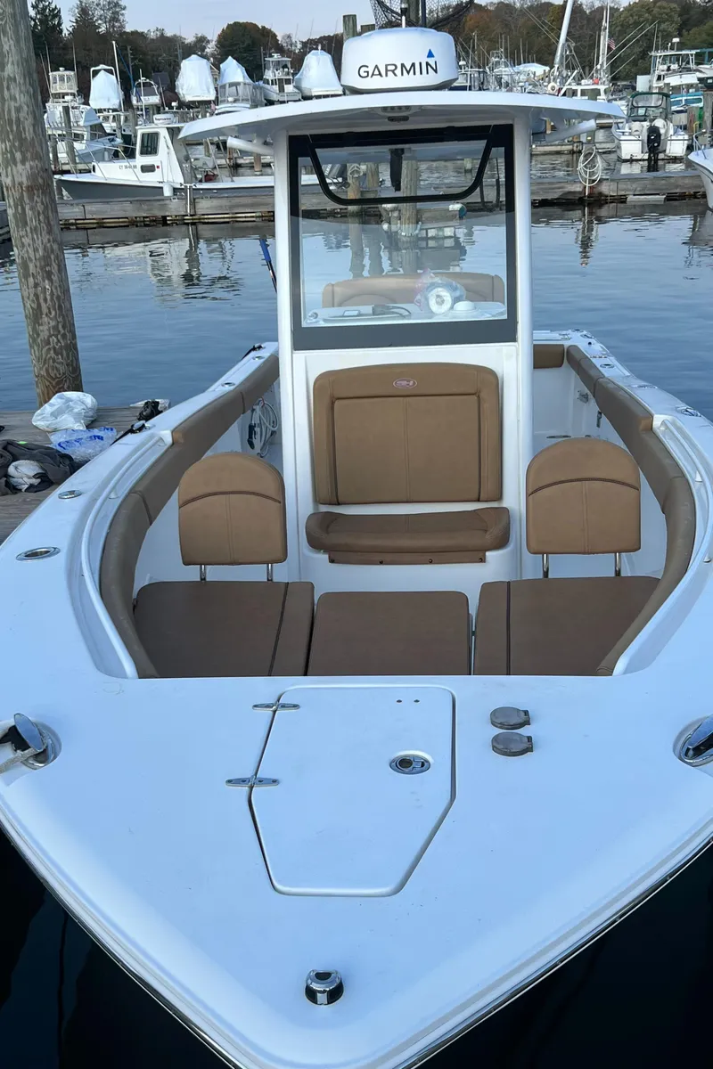 Slide: The Image of 2020 Sea Hunt Gamefish 25 boat with tan seating, docked in a marina. - 47
