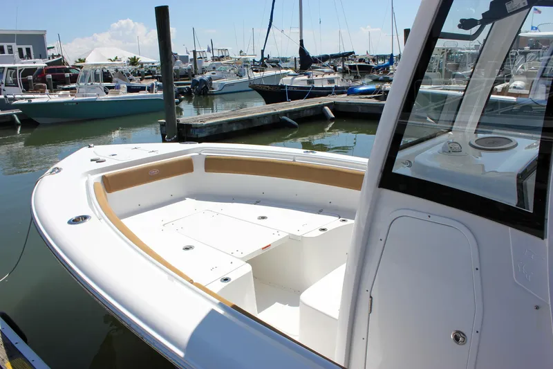 Slide: The Image of 2020 Sea Hunt Gamefish 25 boat docked at marina, showcasing spacious deck and seating. - 5