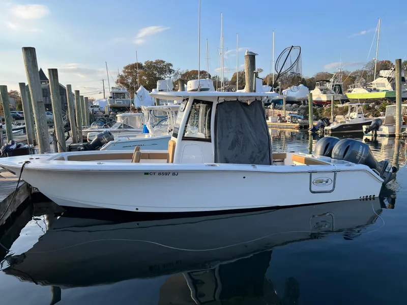 Slide: The Image of 2020 Sea Hunt Gamefish 25 boat docked at a marina. - 6