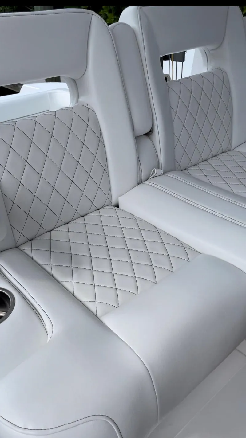 Slide: The Image of 2016 Intrepid 375 Center Console boat with white diamond-stitched seating. - 11