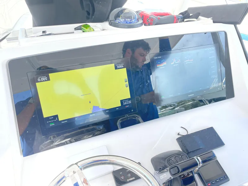 Slide: The Image of 2016 Intrepid 375 Center Console dashboard with navigation and control screens. - 14