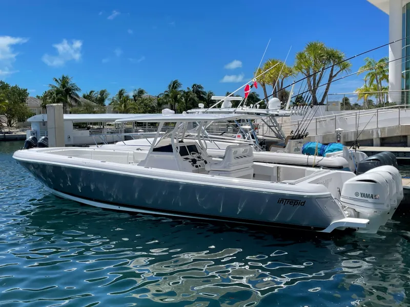 Slide: The Image of 2016 Intrepid 375 Center Console boat docked in a marina. - 2