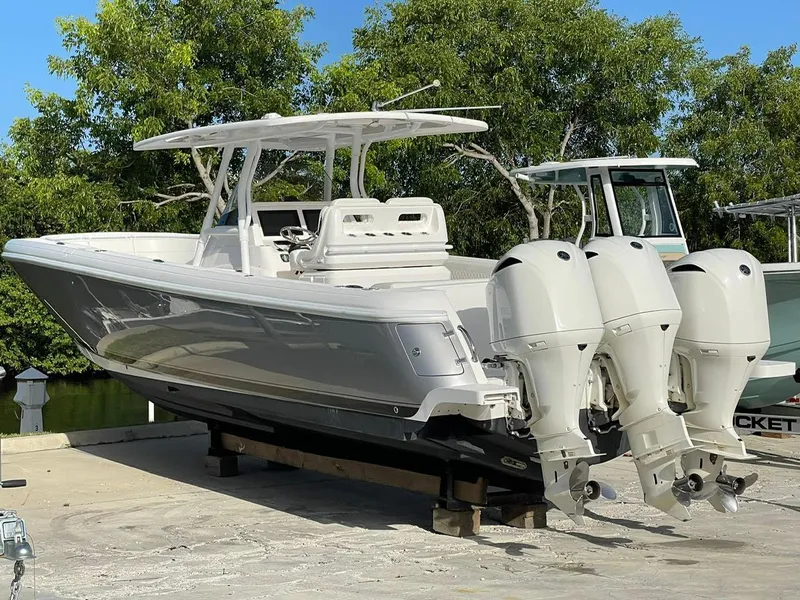 Slide: The Image of 2016 Intrepid 375 Center Console boat with triple outboard engines on a trailer. - 26